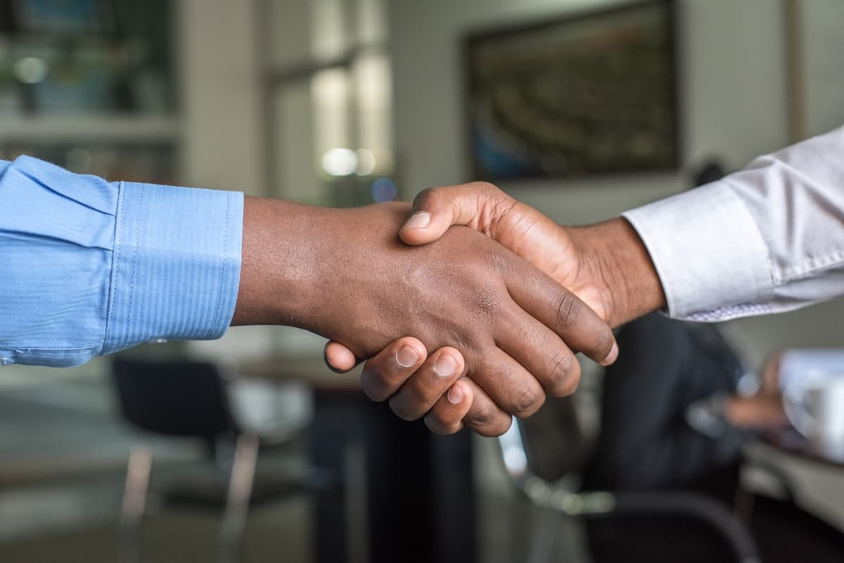 Close-up of a handshake between two professionals, representing a trusted advisory relationship