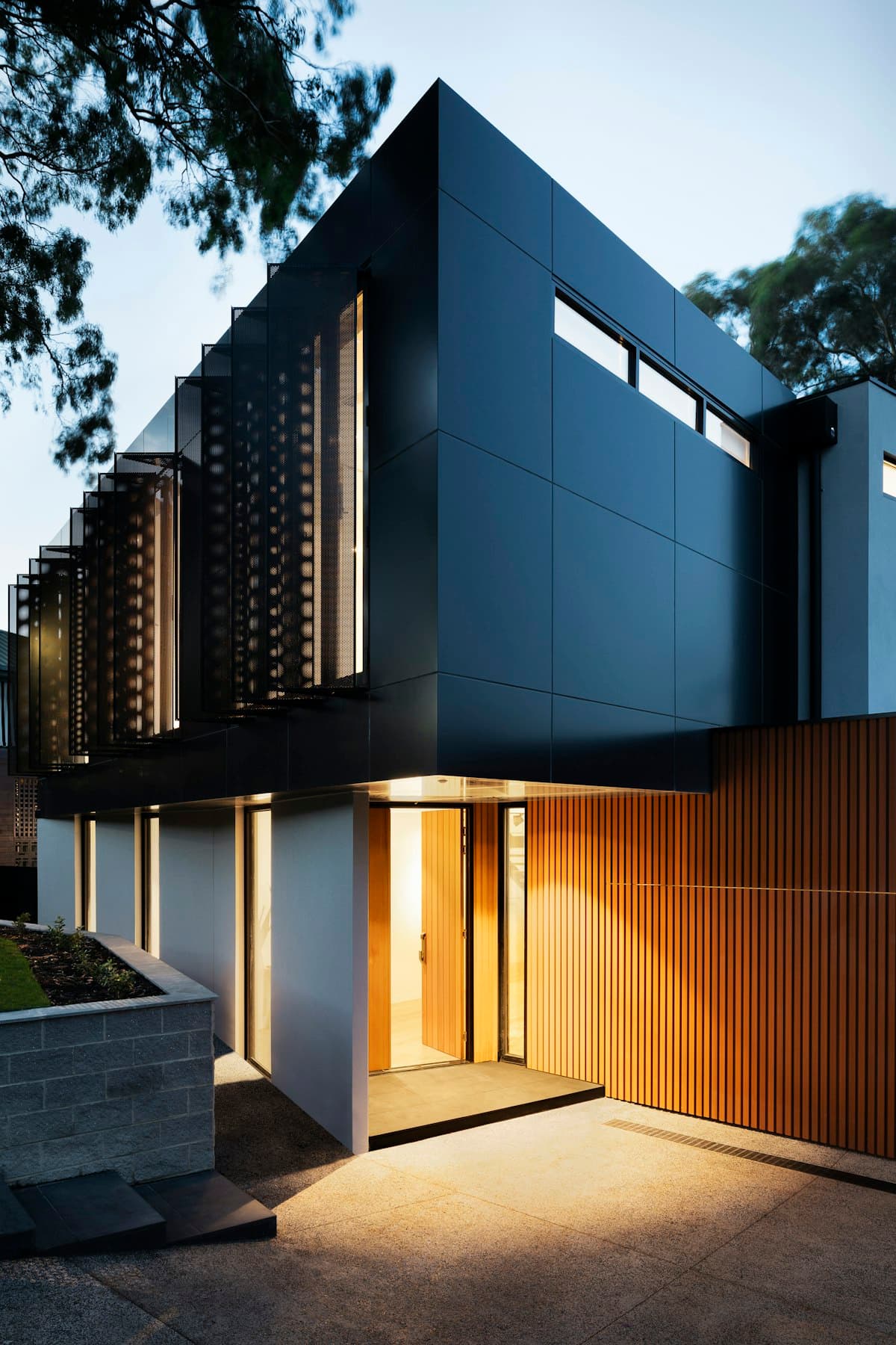 A modern home at dusk with warm interior lighting, representing protection for what matters